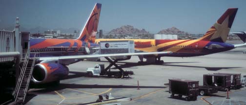 America West 757-2S7, N901AW Arizona taxis past N907WA Phoenix Suns at Phoenix Sky Harbor on July 6, 1997
