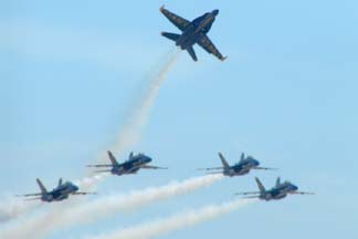 McDonnell-Douglas F/A-18 Hornets of the Blue Angels break into the pattern.